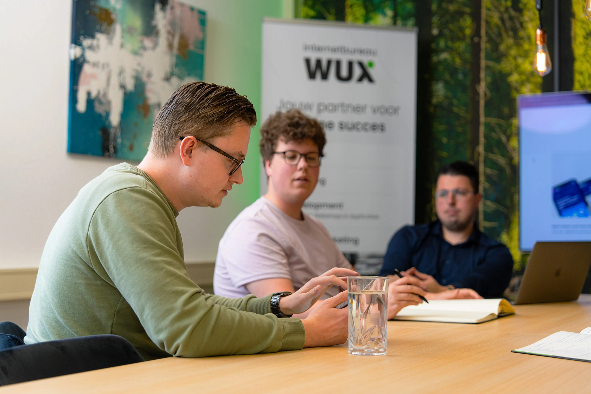 Collega’s overleggen over de ontwikkeling en implementatie van een softwareoplossing voor een klant.