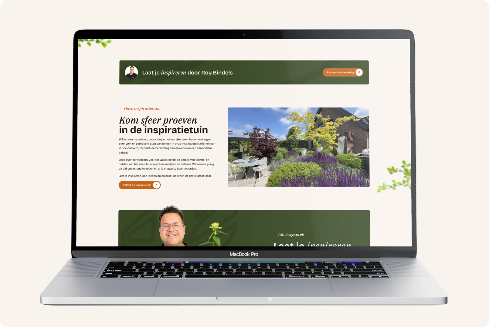 Een geopende MacBook Pro die een sectie van de Bindels Buiten Beleving website over de inspiratietuin toont. Op het scherm staat de uitnodigende titel "Kom sfeer proeven in de inspiratietuin" naast een grote, kleurrijke foto van een prachtig aangelegde showtuin met een terras, zitmeubilair en weelderige beplanting. Boven de sectie is een smalle groene banner te zien met de tekst "Laat je inspireren door Roy Bindels", en onderaan begint een sectie voor het aanvragen van een adviesgesprek.